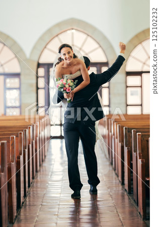 Celebration, carrying and man with bride after wedding in a church, happy and smile for marriage event. Love, comic and couple walking in a building after getting married to celebrate together 125102232