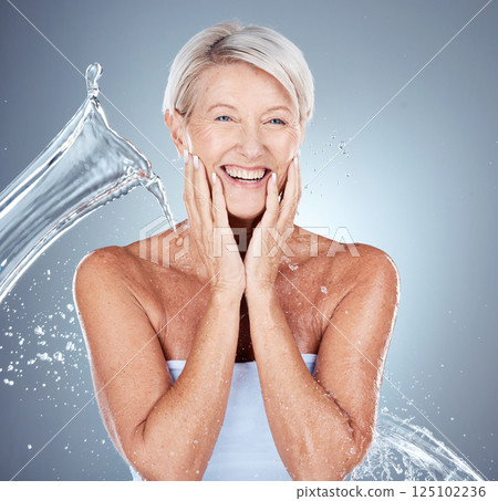 Mature woman, wet or water splash in skincare grooming, morning cleaning routine or healthcare wellness on gray studio background. Portrait, smile or happy elderly beauty model with water drop motion Mature woman, wet or water splash in skincare grooming, morning cleaning routine or healthcare wellness on gray studio background. Portrait, smile or happy elderly beauty model with water drop motion 125102236