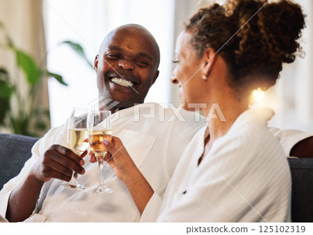 Spa, relax and couple champagne toast for happiness with marriage, love and care at luxury hotel. Wellness, happy and black people smile together for wedding anniversary celebration drinks. 125102319