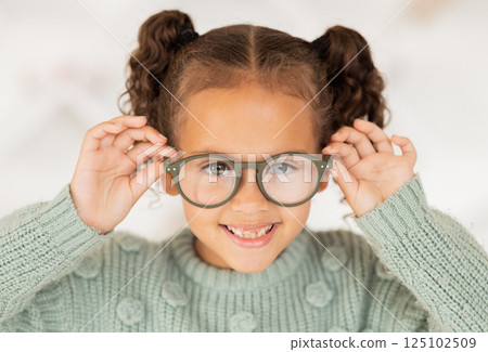 Glasses, frame and portrait of child with vision, eye care and eyes healthcare, wellness and insurance trust, choice and shopping. Happy kid with lens check, test or assessment at an optometry store 125102509