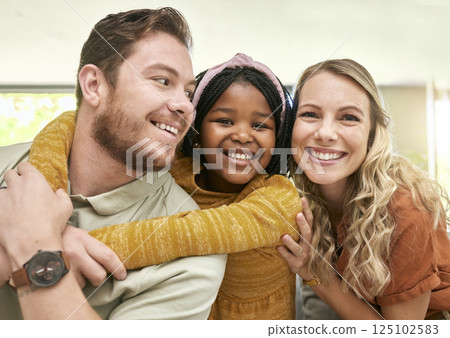 Family, adoption and parents hug child, love and happiness with child care portrait, relax at family home. Happy, bonding and interracial people with foster care and mother, father with kid. Family, adoption and parents hug child, love and happiness with child care portrait, relax at family home. Happy, bonding and interracial people with foster care and mother, father with kid. 125102583