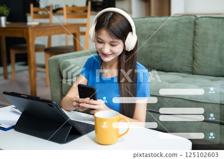 woman uses mobile phone to chat with friends. 125102603