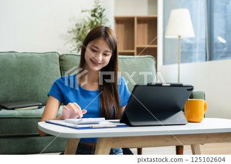 lifestyle of office workers, Woman calculating expenses and using laptop. Home office. Work place. Lifestyle. 125102604