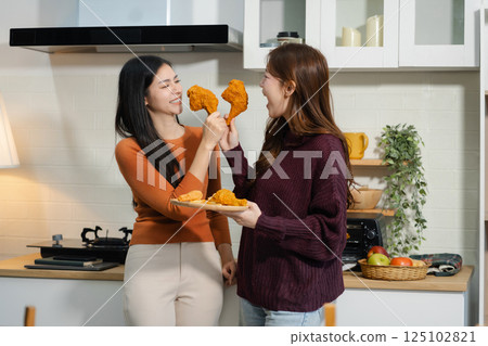 Lifestyle people, Happy two woman enjoys breakfast in the kitchen. 125102821