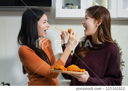 Lifestyle people, Happy two woman enjoys breakfast in the kitchen. 125102822