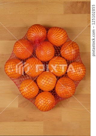 Oranges in a red net bag Oranges in a red net bag 125102855