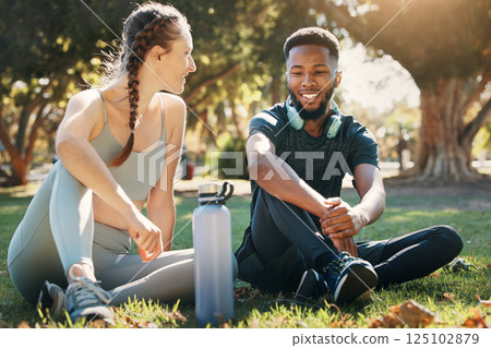 Couple, exercise and relax on grass in nature park for fitness rest, water hydration and interracial health discussion. Diversity, friends conversation and healthy cardio training break together Couple, exercise and relax on grass in nature park for fitness rest, water hydration and interracial health discussion. Diversity, friends conversation and healthy cardio training break together 125102879