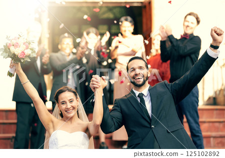 Bride, groom smile and celebrate leaving church holding hands together after wedding ceremony, bridal vows and celebration of love. Happy man, smiling woman and catholic marriage ceremony tradition 125102892