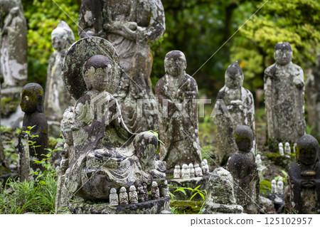 A stone Jizo statue praying with hands together at Kinshoji Temple, the fourth temple of Chichibu. A stone Jizo statue praying with hands together at Kinshoji Temple, the fourth temple of Chichibu. 125102957