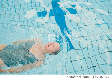 Elderly woman, swimming and pool with float and cardio training for fitness, wellness and physical health. Senior swimmer, water hydrotherapy workout and physical therapy in retirement for healthcare Elderly woman, swimming and pool with float and cardio training for fitness, wellness and physical health. Senior swimmer, water hydrotherapy workout and physical therapy in retirement for healthcare 125102977