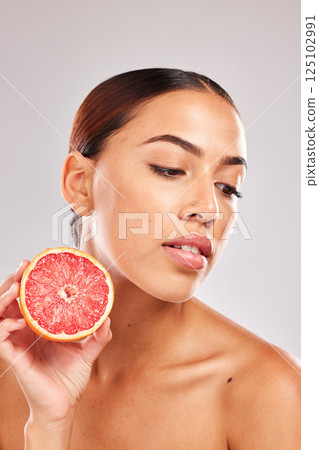 Beauty, skincare and grapefruit cosmetics product for natural skin wellness, citrus and vitamin c detox. Facial spa treatment, organic healthcare and black woman face for a studio advertising mockup Beauty, skincare and grapefruit cosmetics product for natural skin wellness, citrus and vitamin c detox. Facial spa treatment, organic healthcare and black woman face for a studio advertising mockup 125102991