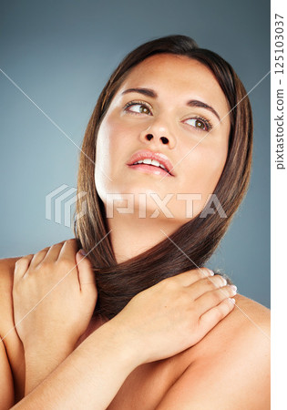 Self love, thinking and woman with hug for beauty, hair care and skincare against a blue background. Spa, idea and cosmetic model with luxury wellness, care for body and glow from self care in studio 125103037