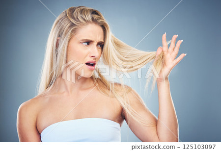 Hair care problem, angry and woman frustrated with damaged hair, split ends or bad haircut. Trichology crisis, hair disaster and model unhappy with hair loss from shampoo routine on studio background 125103097