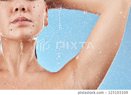 Shower, water and woman cleaning body for self care treatment, hygiene or daily bathroom routine. Body care, healthcare and wellness girl washing skin for natural skincare isolated on blue background 125103109