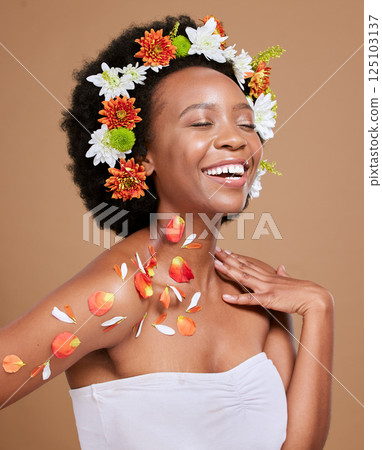 Black woman, happy and flowers in studio for wellness, pamper and nature product against brown background. Smile, girl model and flower, crown and cosmetics for beauty, zen and aesthetic with mockup Black woman, happy and flowers in studio for wellness, pamper and nature product against brown background. Smile, girl model and flower, crown and cosmetics for beauty, zen and aesthetic with mockup 125103137