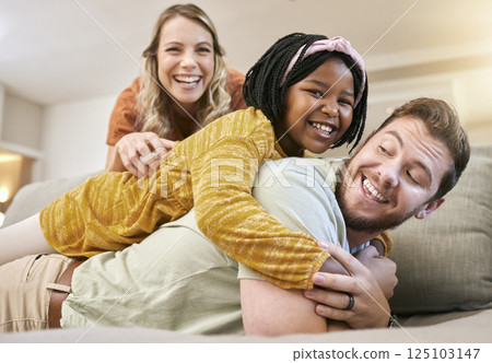 Family, adoption and love with a mother, father and foster child together on living room couch for fun, happiness and bonding. Portrait, smile and trust of man, woman and girl share hug for sopport Family, adoption and love with a mother, father and foster child together on living room couch for fun, happiness and bonding. Portrait, smile and trust of man, woman and girl share hug for sopport 125103147