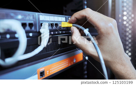 Hands, network engineer and server cable in server room for data, internet or web connection. Cyber security, system administrator and maintenance of computer wire to prevent error, glitch or issues 125103199