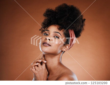 Beauty, fashion and black woman with nature hair or afro on brown studio background for skincare, self care and hair care. Portrait of African model with smile for cosmetics, make up and dermatology 125103200