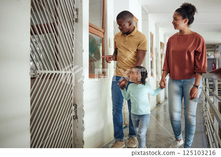 Black family, animal shelter and planning adoption with mother, father and child walking together inside vet building for charity or volunteer work. Man, woman and girl together at pet ngo center 125103216