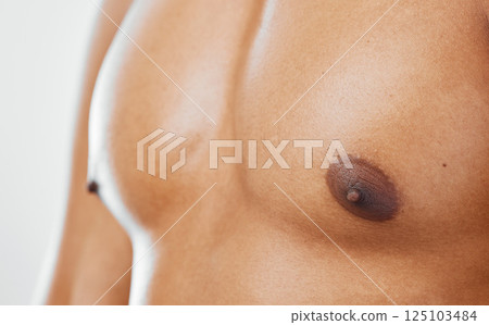 Chest, human body and man in studio to show nipple, anatomy and muscle for health, wellness and fitness of a bodybuilder. Closeup of a model with motivation for exercise, sports training and workout Chest, human body and man in studio to show nipple, anatomy and muscle for health, wellness and fitness of a bodybuilder. Closeup of a model with motivation for exercise, sports training and workout 125103484