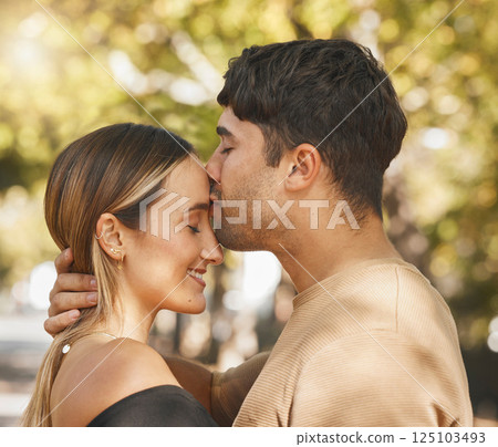 Kiss, love and romance with a couple bonding outdoor during a date on a summer day. Happy, trust and smile with a young man and woman kissing outside together while dating or being romantic Kiss, love and romance with a couple bonding outdoor during a date on a summer day. Happy, trust and smile with a young man and woman kissing outside together while dating or being romantic 125103493