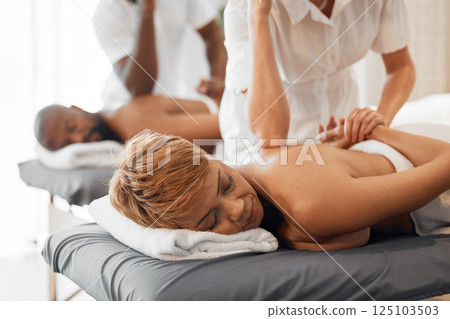 Massage, table and relax black woman or couple at a spa with physical therapy worker hands for stress, muscle and pain health, wellness and healing. Peace, calm and african people back treatment Massage, table and relax black woman or couple at a spa with physical therapy worker hands for stress, muscle and pain health, wellness and healing. Peace, calm and african people back treatment 125103503