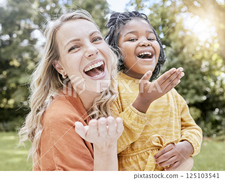 Adoption, mother and girl outdoor, smile or happy being loving, bonding or happy together. Portrait, adopted child or black girl with foster mother, happiness or love for care, relax and quality time Adoption, mother and girl outdoor, smile or happy being loving, bonding or happy together. Portrait, adopted child or black girl with foster mother, happiness or love for care, relax and quality time 125103541