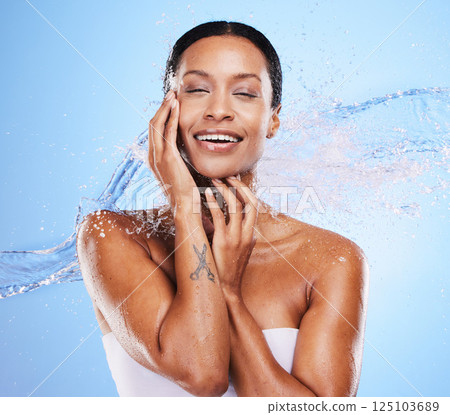 Shower, water and black woman with splash and beauty, grooming and hygiene with clean and wet against blue studio background. Natural cosmetics, fresh and hydration, wellness and healthy skin mockup. Shower, water and black woman with splash and beauty, grooming and hygiene with clean and wet against blue studio background. Natural cosmetics, fresh and hydration, wellness and healthy skin mockup. 125103689