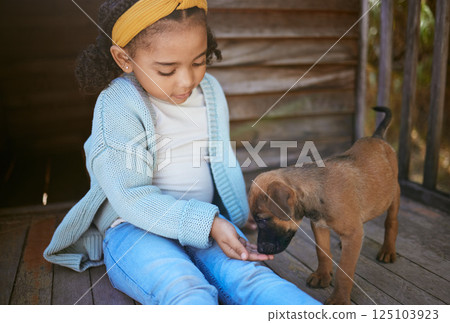Child, puppy dog and smell hand for trust, friendship and love of new, domestic animal adoption and child development. Pet shelter, friendly german shepherd and girl learning pet care while bonding Child, puppy dog and smell hand for trust, friendship and love of new, domestic animal adoption and child development. Pet shelter, friendly german shepherd and girl learning pet care while bonding 125103923
