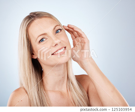 Woman, face glow or blonde hair care on studio background in keratin treatment success, growth progress or color highlights. Portrait, smile or happy beauty model with makeup, cosmetics or hairstyle 125103954