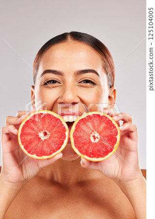 Skincare, beauty and portrait of woman with grapefruit in hands on white background in studio. Wellness, body care and female with fruit for organic, natural and healthy cosmetics and makeup products Skincare, beauty and portrait of woman with grapefruit in hands on white background in studio. Wellness, body care and female with fruit for organic, natural and healthy cosmetics and makeup products 125104005