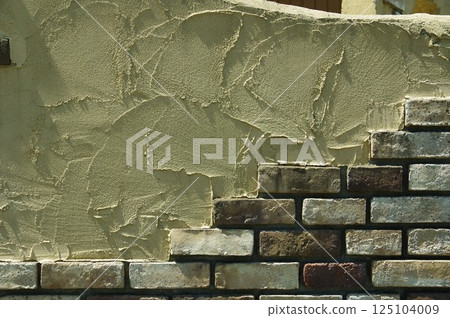 Modern exterior with brick tiles and painting on mortar wall 1 125104009