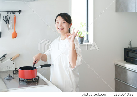 Woman cooking (OK, successful) Woman cooking (OK, successful) 125104352