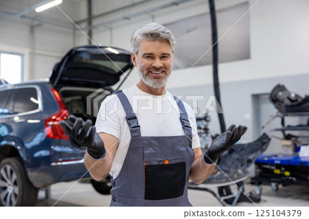 Worker in automotive industry doing diagnostics on transport vehicle 125104379