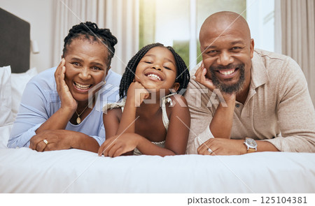 Love, grandparents and girl on bed, with smile and happy together to relax. Portrait, black family and with daughter in bedroom, bonding and being loving for happiness, quality time and on weekend. Love, grandparents and girl on bed, with smile and happy together to relax. Portrait, black family and with daughter in bedroom, bonding and being loving for happiness, quality time and on weekend. 125104381