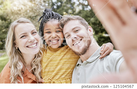 Adoption, family and with black girl for selfie, smile and happy together outdoor for bonding. Love, foster parents and daughter with mother, father and loving for break, holiday and happiness. Adoption, family and with black girl for selfie, smile and happy together outdoor for bonding. Love, foster parents and daughter with mother, father and loving for break, holiday and happiness. 125104567