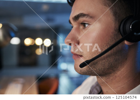Call center, night and face of man with microphone for consulting for customer service, telemarketing and sales in an office. Male working in CRM, contact us and telecom business for support and help 125104574