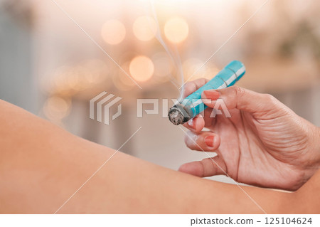 Hands, aromatherapy and relax with a massage therapist and client using moxibustion therapy in a wellness center. Spa, health and luxury with a masseuse massaging a woman customer relaxation 125104624
