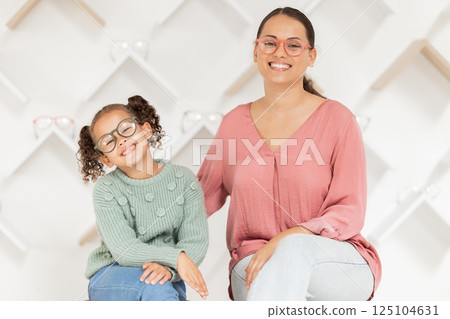 Family, eye care and glasses on mother and child in optics store for shopping, optometry and health care while advertising lens or frame choice. Portrait of woman and girl happy with vision insurance 125104631
