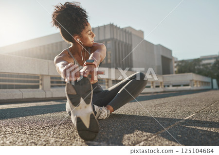 Fitness, city and woman stretching her legs in the street before a cardio workout, running or training. Sports, health and lady doing a warm up stretch for an outdoor exercise in the urban town road. 125104684
