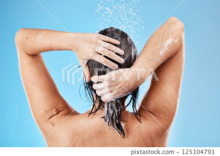 Hair, wash and woman in shower with water for haircare, cleaning and health on a blue studio background. Bathroom, cleansing and hygiene for hair grooming with shampoo or soap while showering Hair, wash and woman in shower with water for haircare, cleaning and health on a blue studio background. Bathroom, cleansing and hygiene for hair grooming with shampoo or soap while showering 125104791