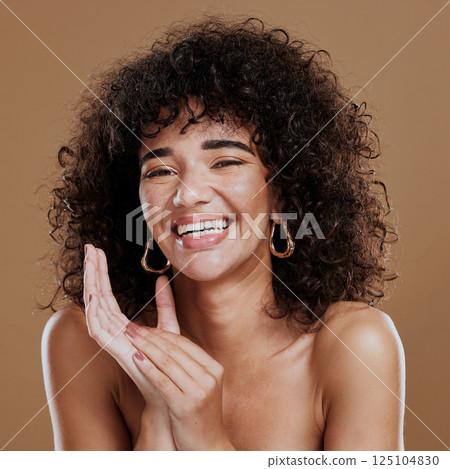 Comic, makeup and face of a woman with an afro hair care, skincare and glow from cosmetics against a brown studio background. Beauty, happy and portrait of a model with wellness and happiness Comic, makeup and face of a woman with an afro hair care, skincare and glow from cosmetics against a brown studio background. Beauty, happy and portrait of a model with wellness and happiness 125104830