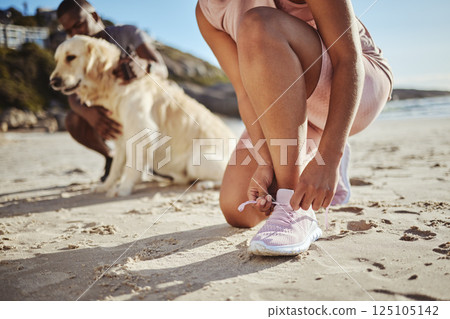 Fitness, exercise and tying shoelace on running shoes while outdoor at the beach for a workout, training and cardio in nature. Hands of an athlete woman with sneakers while out for a run on sand 125105142