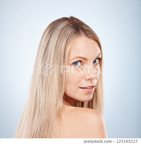 Hair, woman and portrait of a blonde woman with hairstyle or treatment for beauty and haircare. Hair style, hair care and blond female face for aesthetic, clean healthy hair in a studio salon 125105227