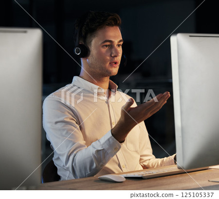 Call center, night and man using, computer during consultation for telemarketing, sales and customers support in a dark CRM office. Male talking online for telecom, contact us and help with faq 125105337