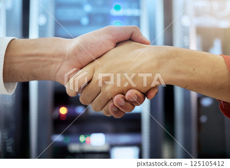 Handshake, partnership and teamwork of server room of data center workers shaking hands for achievement, b2b deal and agreement. Man in woman together in collaboration for network, IT and support 125105412