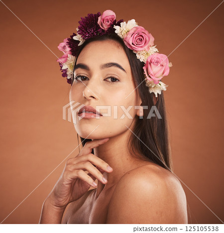 Flower, crown and woman with beauty, makeup and portrait against a brown studio background. Spring, cosmetics and face of a young model with flowers for summer, harmony and accessory in hair Flower, crown and woman with beauty, makeup and portrait against a brown studio background. Spring, cosmetics and face of a young model with flowers for summer, harmony and accessory in hair 125105538