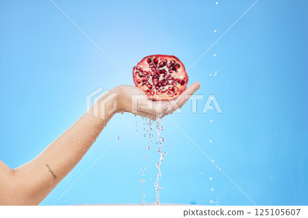 Pomegranate, water and hand on studio background mockup for skincare, detox and beauty product marketing, advertising or promotion. Red fruit, healthy food and shower water drop splash for vitamin c Pomegranate, water and hand on studio background mockup for skincare, detox and beauty product marketing, advertising or promotion. Red fruit, healthy food and shower water drop splash for vitamin c 125105607