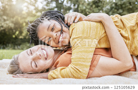 Happy family, mother hug and nature of a interracial girl and mama with love in a picnic park. Portrait of happy, relax and smile of a mother and daughter together on a floor with diversity adoption Happy family, mother hug and nature of a interracial girl and mama with love in a picnic park. Portrait of happy, relax and smile of a mother and daughter together on a floor with diversity adoption 125105629