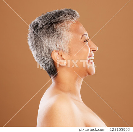 Mature woman, face and skincare glow on studio background profile in wellness, dermatology or self care. Smile, happy or Indian beauty model with gray hair, makeup cosmetics or anti aging cosmetology Mature woman, face and skincare glow on studio background profile in wellness, dermatology or self care. Smile, happy or Indian beauty model with gray hair, makeup cosmetics or anti aging cosmetology 125105903